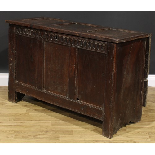 1569 - A 17th century oak blanket chest, hinged top, nulled frieze, three panel front, 74cm high, 115cm wid... 