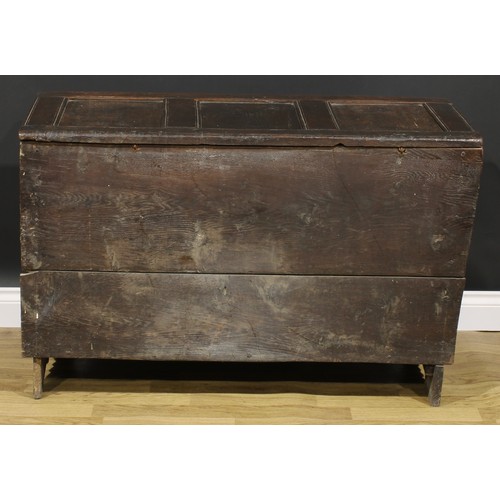 1569 - A 17th century oak blanket chest, hinged top, nulled frieze, three panel front, 74cm high, 115cm wid... 