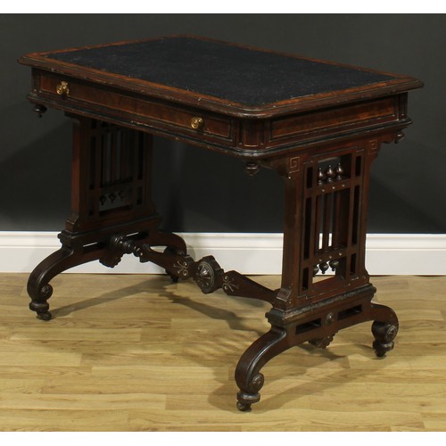 1843 - A late Victorian Aesthetic Movement walnut and mahogany writing table, rounded rectangular top above... 