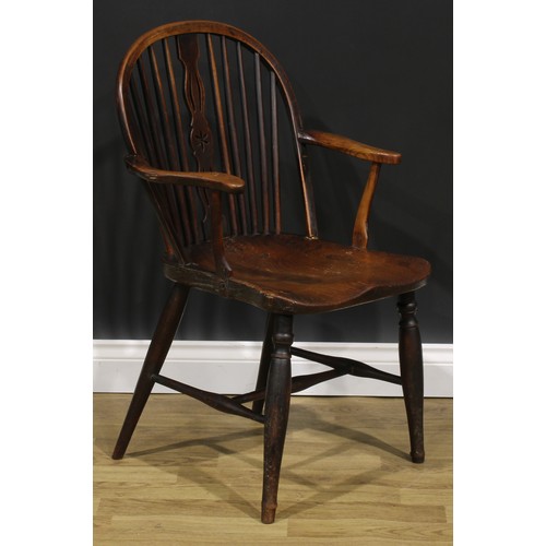 1575 - A 19th century ash, beech and elm negative-star-back Windsor elbow chair, hoop back, shaped and pier... 