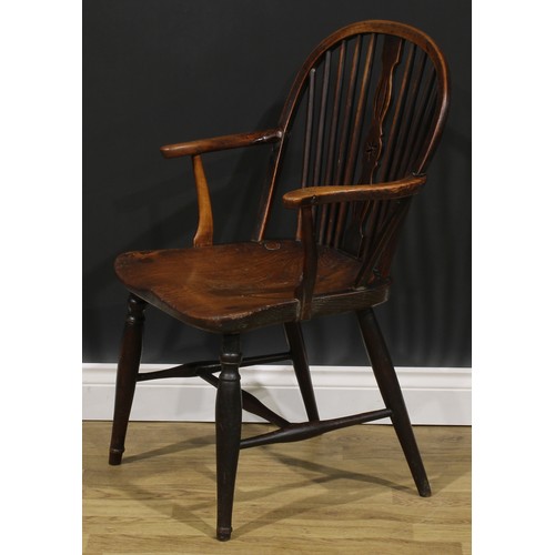 1575 - A 19th century ash, beech and elm negative-star-back Windsor elbow chair, hoop back, shaped and pier... 