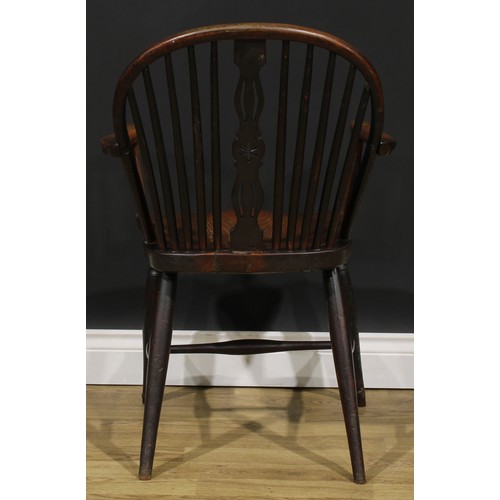 1575 - A 19th century ash, beech and elm negative-star-back Windsor elbow chair, hoop back, shaped and pier... 