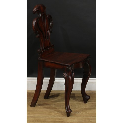 2583 - A Victorian mahogany hall chair, shaped and pierced back carved with acanthus, serpentine seat, cabr... 