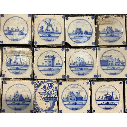 2545 - A quantity of Delftware blue and white tiles, predominantly decorated in the traditional manner with... 