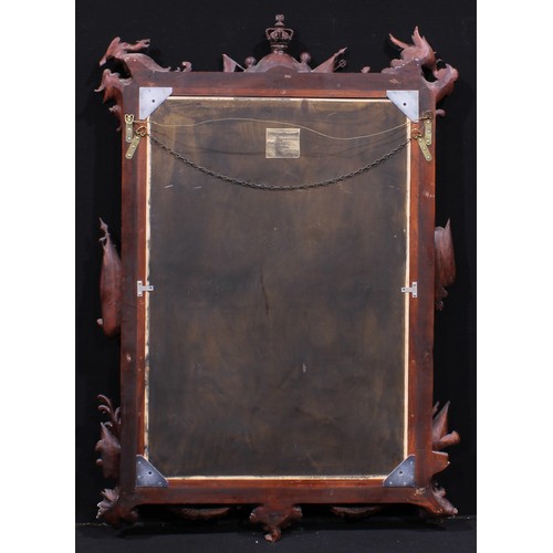 2438 - A Baroque Revival hardwood chimney glass, bevelled mirror plate, the frame carved with triumphant re... 