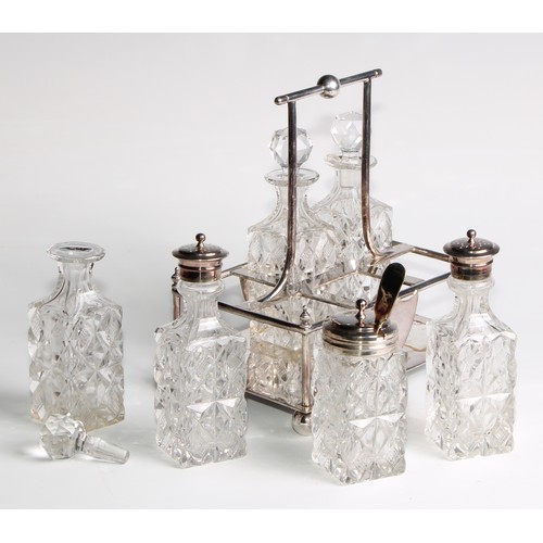 817 - A late Victorian E.P.N.S rectangular six-bottle cruet, in the Christopher Dresser taste, ball feet, ... 