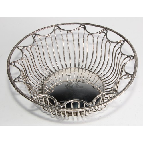 1028 - A pair of George V Neo-Classical Revival silver circular wirework bread or cake baskets, crested, 21... 