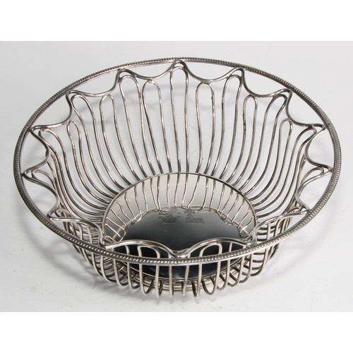 1028 - A pair of George V Neo-Classical Revival silver circular wirework bread or cake baskets, crested, 21... 