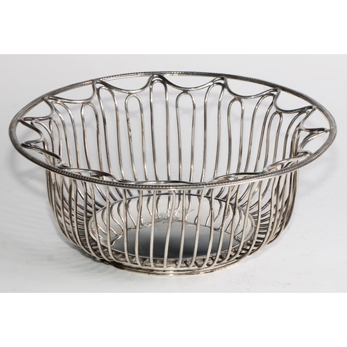 1028 - A pair of George V Neo-Classical Revival silver circular wirework bread or cake baskets, crested, 21... 