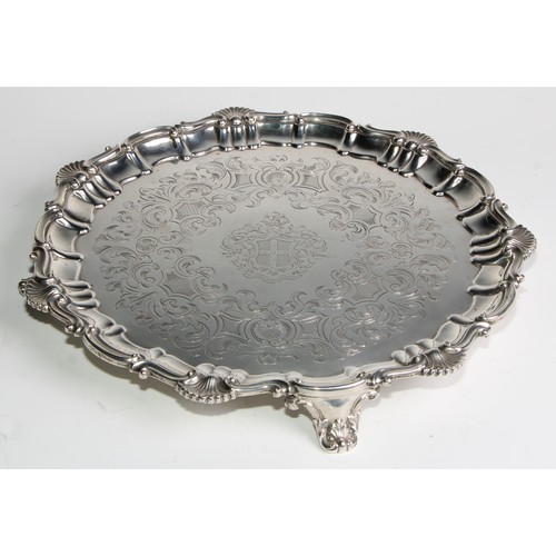 1102 - A Victorian silver shaped circular salver, fluted shell and S-scroll border, the armorial field engr... 