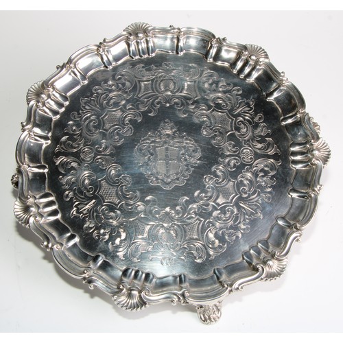 1102 - A Victorian silver shaped circular salver, fluted shell and S-scroll border, the armorial field engr... 