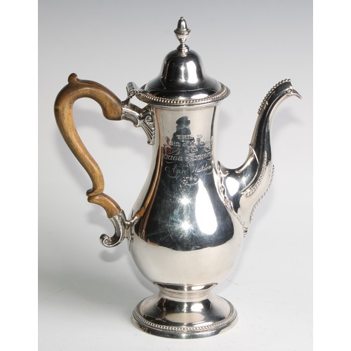 910 - A George III Provincial silver baluster coffee pot, hinged domed cover with acorn finial, beaded bor... 