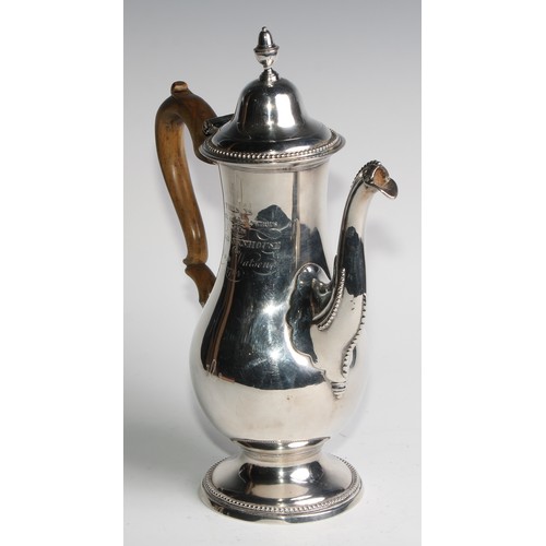 910 - A George III Provincial silver baluster coffee pot, hinged domed cover with acorn finial, beaded bor... 