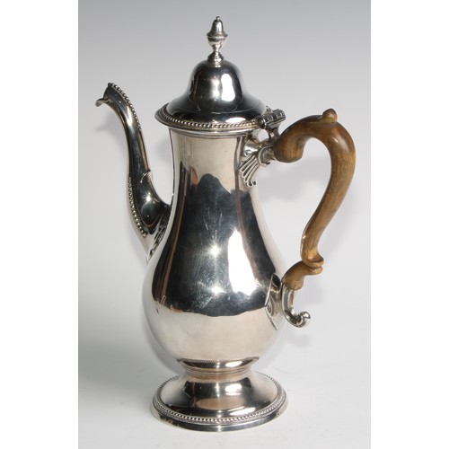 910 - A George III Provincial silver baluster coffee pot, hinged domed cover with acorn finial, beaded bor... 