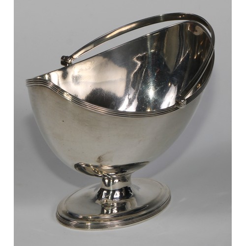 916 - A George III silver boat shaped pedestal sugar basket, reeded borders and swing handle, navette shap... 