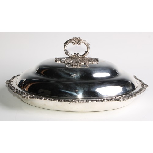 933 - A George III silver oval entree dish, of Irish interest, the ogee cover with acanthus C-scroll loop ... 