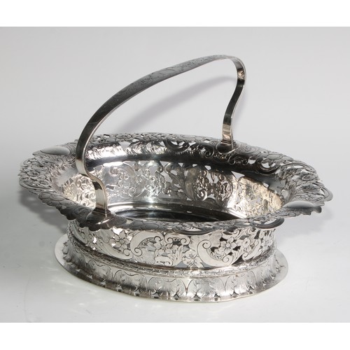 894 - A George II Revival silver oval table centre basket, arched handle, the shaped border pierced and ch... 