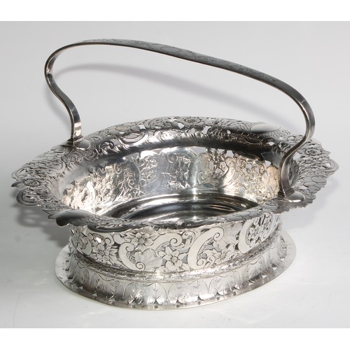 894 - A George II Revival silver oval table centre basket, arched handle, the shaped border pierced and ch... 