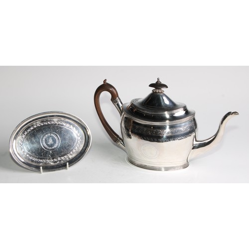 935 - A George III silver oval teapot and stand, bright-cut and wriggle-work engraved throughout, hinged d... 