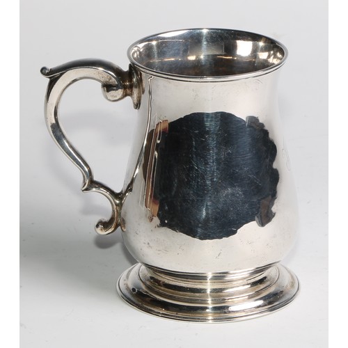 897 - A George II silver bell shaped mug, scroll-capped handle, skirted base, 12cm high, London 1748, 308g