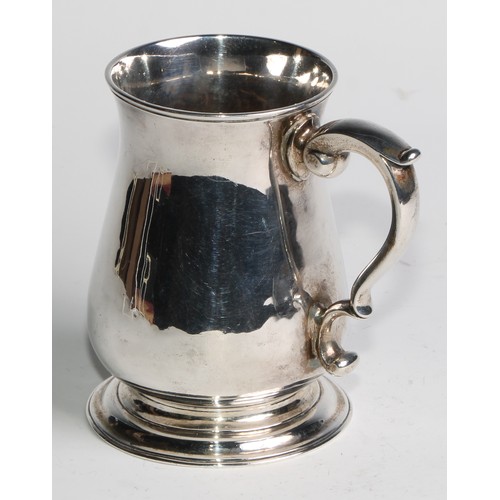 897 - A George II silver bell shaped mug, scroll-capped handle, skirted base, 12cm high, London 1748, 308g