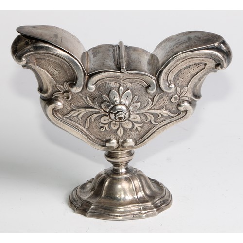 1072 - A South European silver pedestal liturgical incense boat, chased with flowers and C-scrolls, twin hi... 