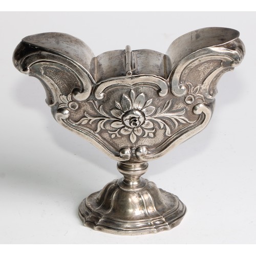 1072 - A South European silver pedestal liturgical incense boat, chased with flowers and C-scrolls, twin hi... 