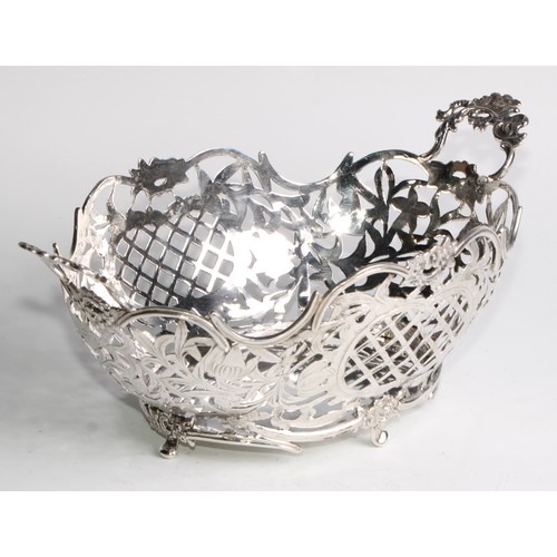 884 - A Dutch silver boat shaped cake basket, pierced and engraved with flowers, scrolling leaves, and tre... 