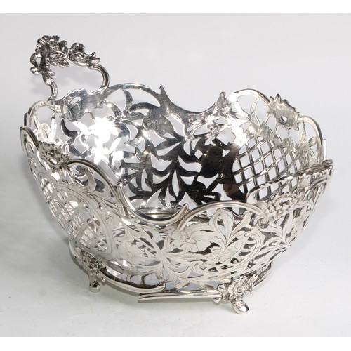 884 - A Dutch silver boat shaped cake basket, pierced and engraved with flowers, scrolling leaves, and tre... 