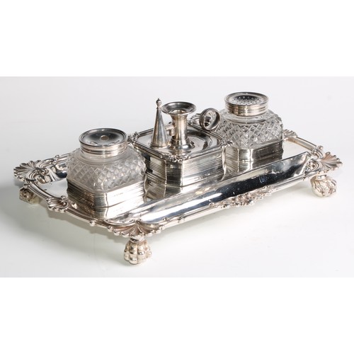 938 - A George III silver shaped rectangular partners' inkstand, central wafer box enclosed by a taperstic... 