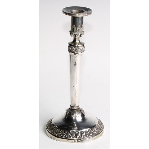 1014 - A pair of Continental silver circular table candlesticks, chased and applied with fruiting vine and ... 