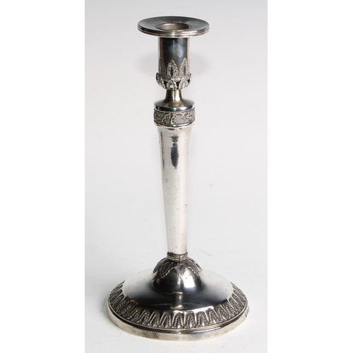 1014 - A pair of Continental silver circular table candlesticks, chased and applied with fruiting vine and ... 