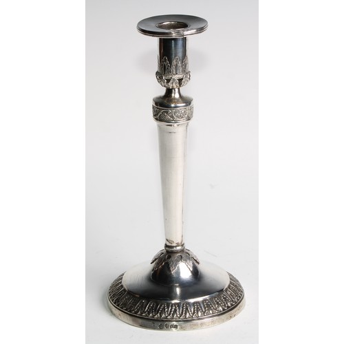 1014 - A pair of Continental silver circular table candlesticks, chased and applied with fruiting vine and ... 