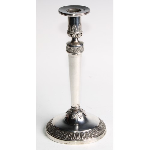 1014 - A pair of Continental silver circular table candlesticks, chased and applied with fruiting vine and ... 