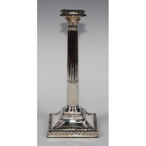 823 - A pair of George III Old Sheffield Plate stop-fluted Corinthian column candlesticks, beaded nozzles,... 