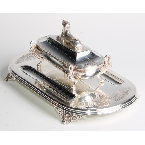 846 - An Egyptian Revival E.P.N.S inkstand, the cover crested by a sphinx, enclosing a pair of wells, the ... 