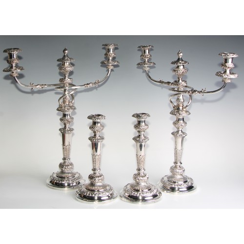 827 - A post-Regency Old Sheffield Plate four-piece table lighting suite, comprising a pair of three-light... 