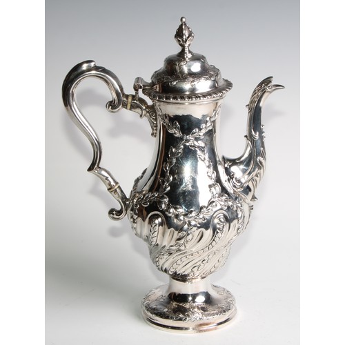 1148 - An early George III silver baluster coffee pot, wrythen half-fluted and chased with leafy branches, ... 