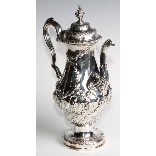 1148 - An early George III silver baluster coffee pot, wrythen half-fluted and chased with leafy branches, ... 