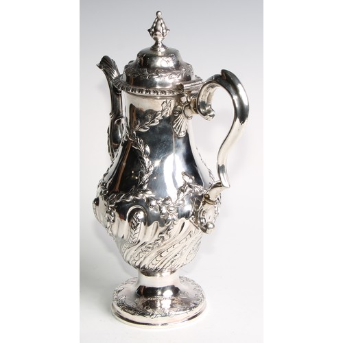 1148 - An early George III silver baluster coffee pot, wrythen half-fluted and chased with leafy branches, ... 