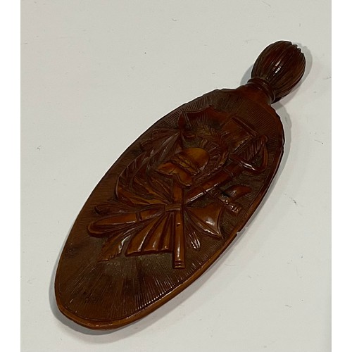 2132 - A 19th century coquilla nut scent bottle, carved with triumphant regalia and lyre, 7.5cm long, c.180... 