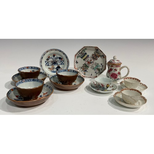 479 - A set of three Chinese Batavian tea bowls and saucers, the interiors decorated in underglaze red and... 