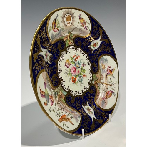 288 - A Continental porcelain plate, probably Sevres, the field painted with flowers in gilt c-scroll cart... 