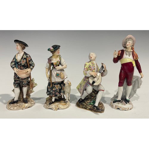 295 - A Meissen figure, of a musician, he sits playing the lute wearing long floral yellow coat, blue cros... 