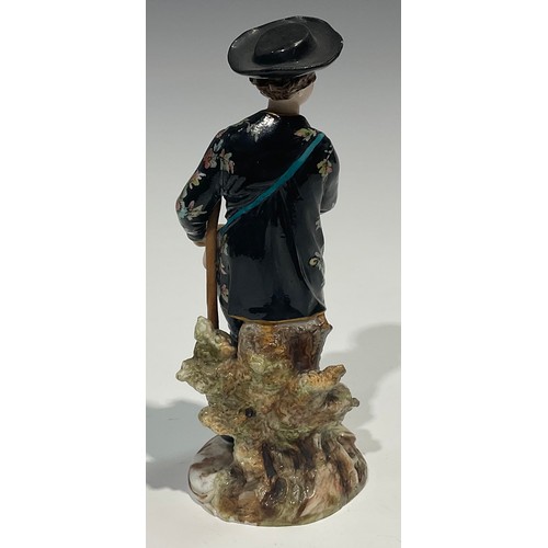 295 - A Meissen figure, of a musician, he sits playing the lute wearing long floral yellow coat, blue cros... 