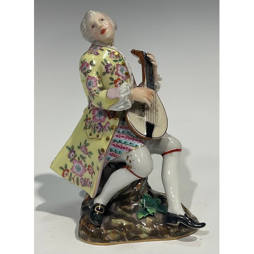 295 - A Meissen figure, of a musician, he sits playing the lute wearing long floral yellow coat, blue cros... 