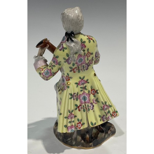 295 - A Meissen figure, of a musician, he sits playing the lute wearing long floral yellow coat, blue cros... 