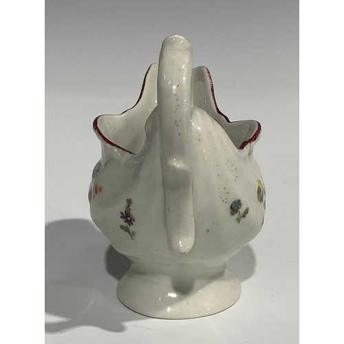 235 - A Derby dolphin ewer cream jug, in relief with shell moulding, painted in polychrome with flowers an... 