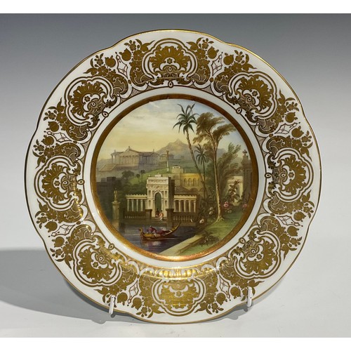 171 - A shaped circular cabinet plate, probably Coalport, the field painted with temples in an exotic moun... 