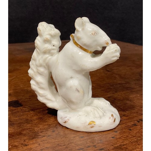 139 - A Rockingham porcelain model, of a squirrel eating a nut, white picked out in gilt, incised marks to... 